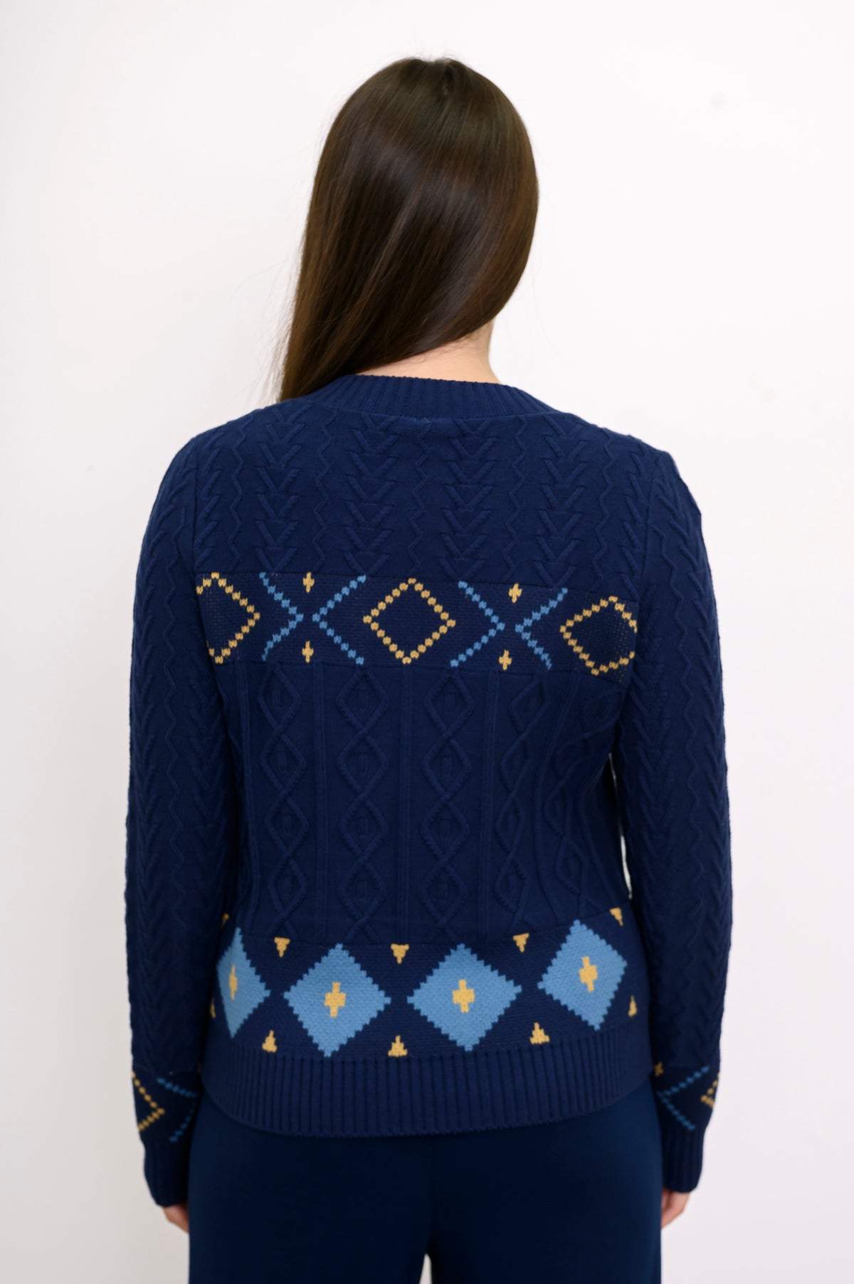 Back view of a women's patterned indigo-colored sweater, focusing on the intricate retro diamond knit design.