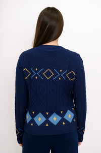 Back view of a women's patterned indigo-colored sweater, focusing on the intricate retro diamond knit design.