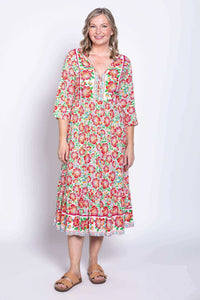 Front view of model wearing lightweight batik midi dress with colorful floral print