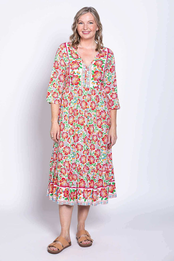 Front view of model wearing lightweight batik midi dress with colorful floral print