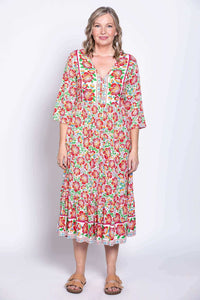 Model in colorful batik dress standing forward in a relaxed pose