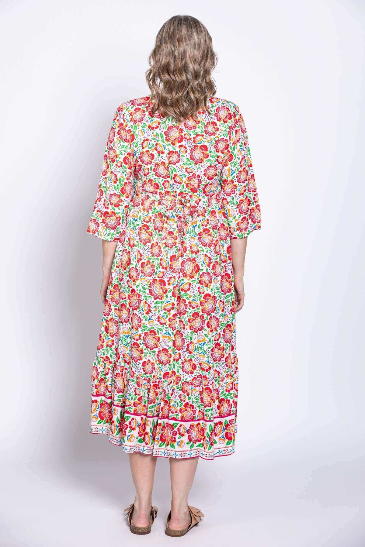 Back view of model showing the fit and length of floral batik midi dress
