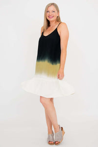 Woman twirling in an ombre black, olive, and white knee-length dress