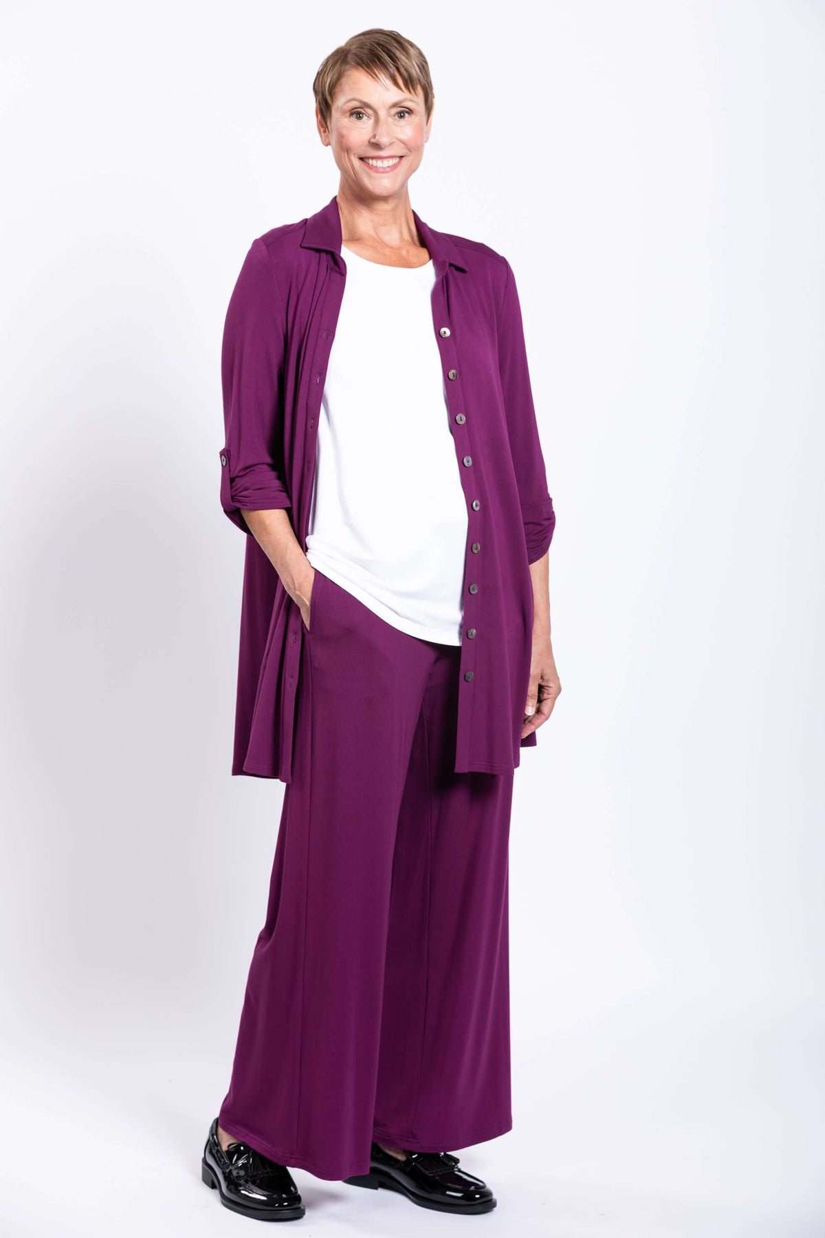 Model wearing open plum bamboo tunic with white inner top and matching pants