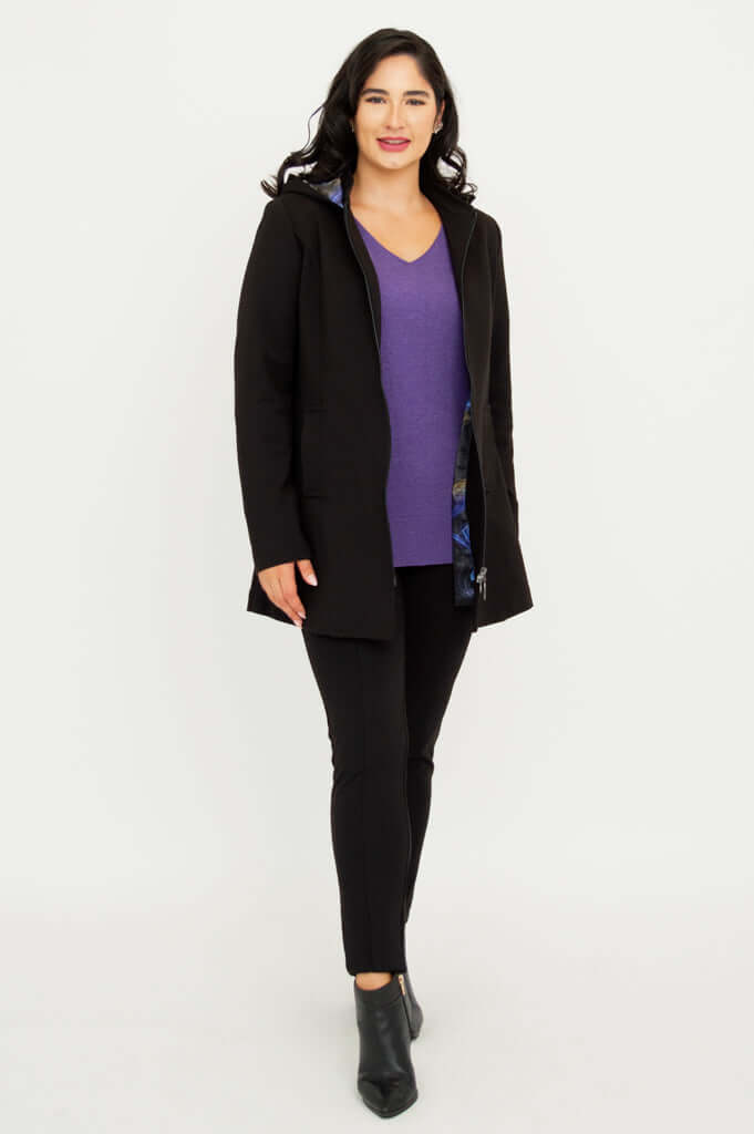 Model wearing The Highlands Coat open over a purple sweater and black pants