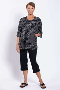 Model with hand in pocket, showcasing the Palace Blouse's patterned pocket detail