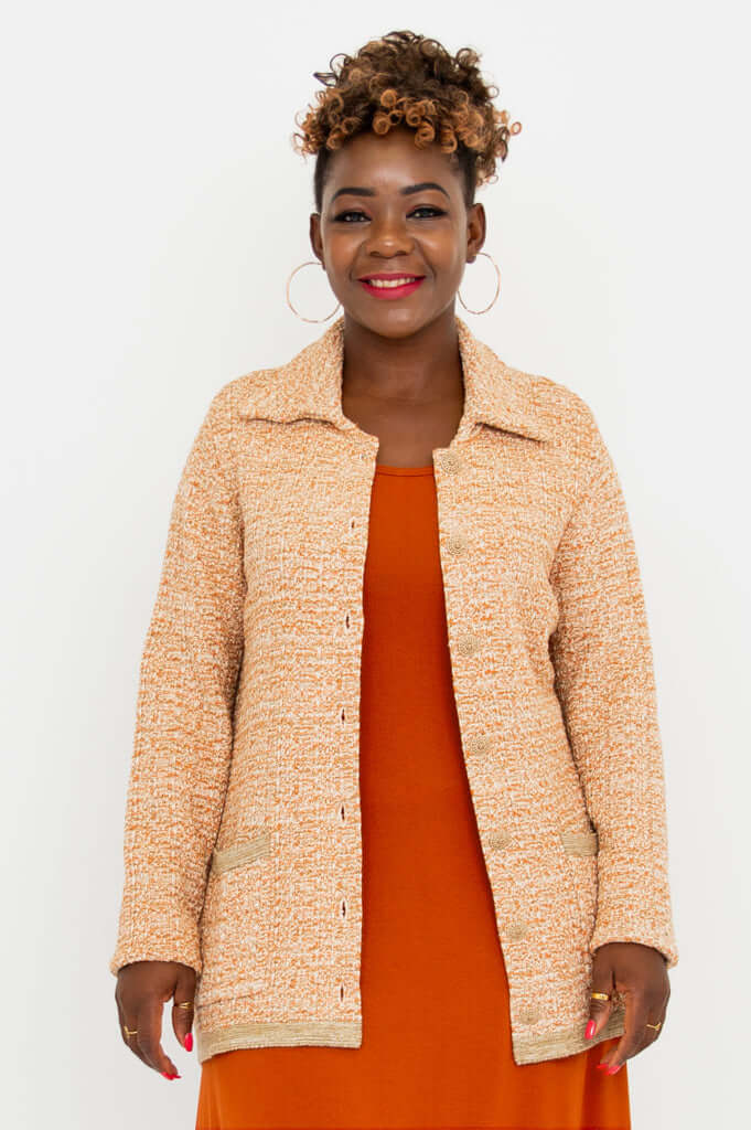 Front partial open view of Parisian Chanel Cardigan with orange dress underneath