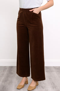 close up view of brown corduroy pants featuring an elastic waistband and pockets