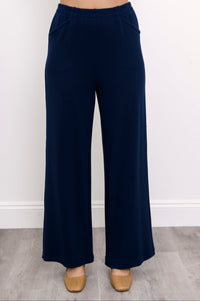 Close-up front view of woman wearing high-waisted pants with relaxed fit and pockets