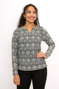 Women's long sleeve floral lace motif blouse with a notched neckline and straight hem.