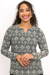 Close-up of a women's floral lace print bamboo long sleeve blouse featuring a notched sweetheart neckline.