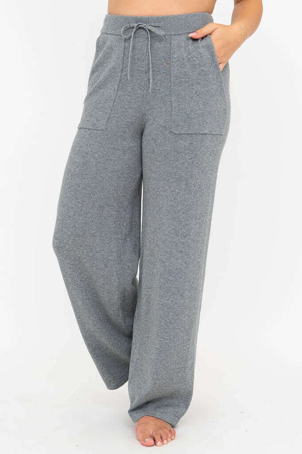 Front view of grey wide leg cotton knit pants with drawstring waist and patch pockets