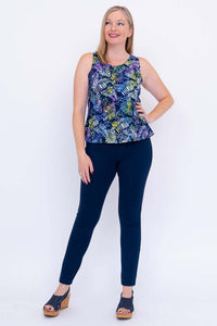 Woman posing with hand on hip in Dee Tank leaf print top and navy pants