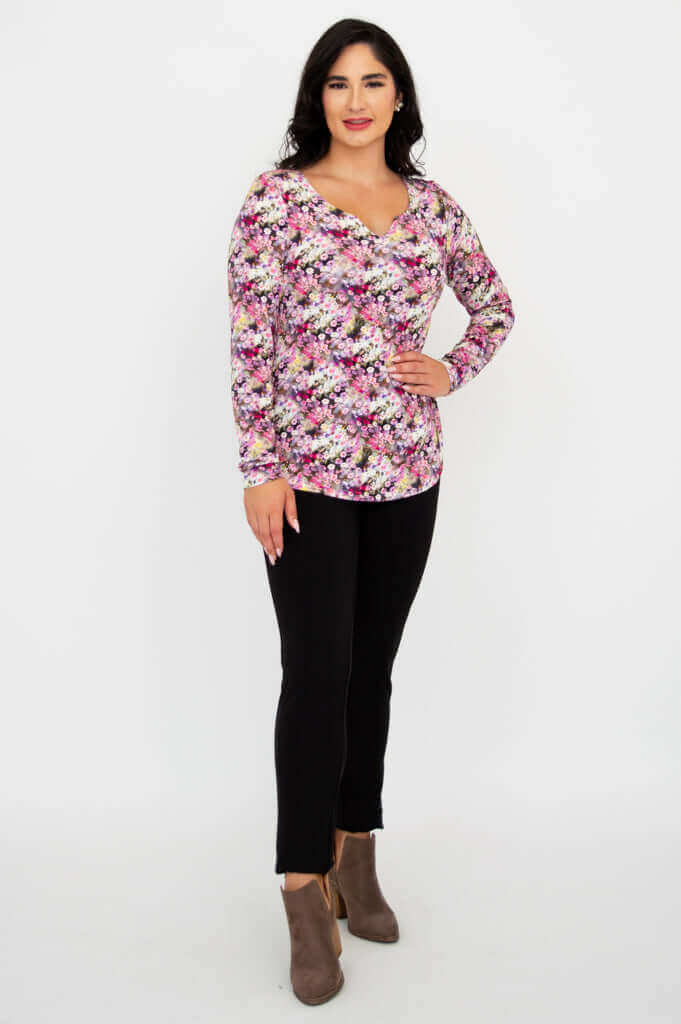Woman posing in floral sweetheart bamboo top and black pants, front stance