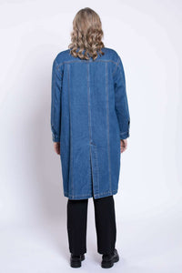 Rear view of Geraldine longline denim jacket worn by model