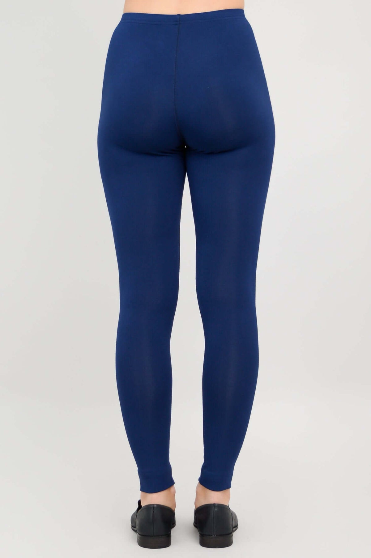 Rear view of model wearing Ruby leggings in deep blue