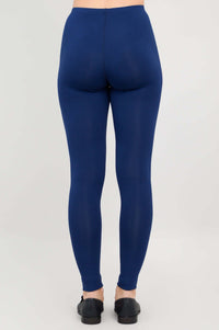 Rear view of model wearing Ruby leggings in deep blue