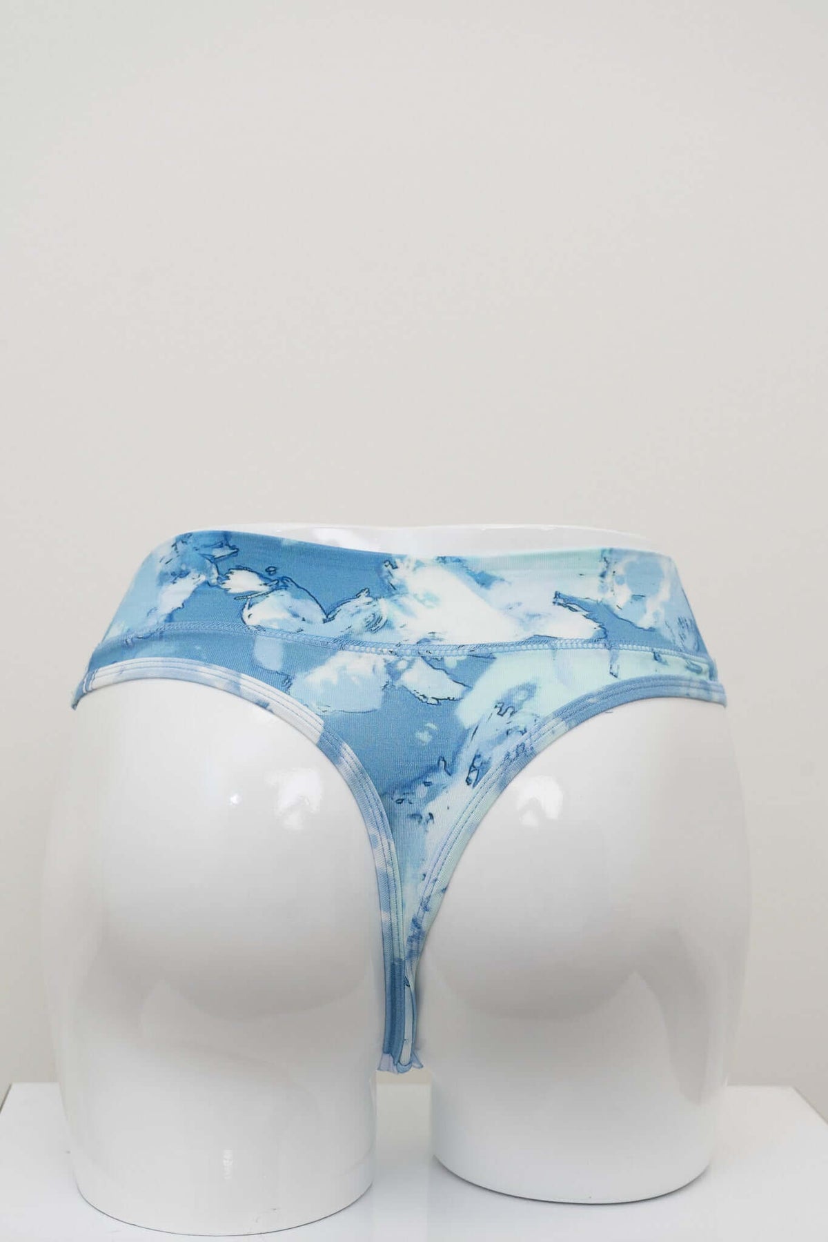 Rear view of high rise blue patterned thong underwear on mannequin