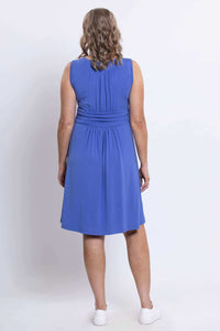 Back view of woman wearing blue bamboo jersey dress with ruched details