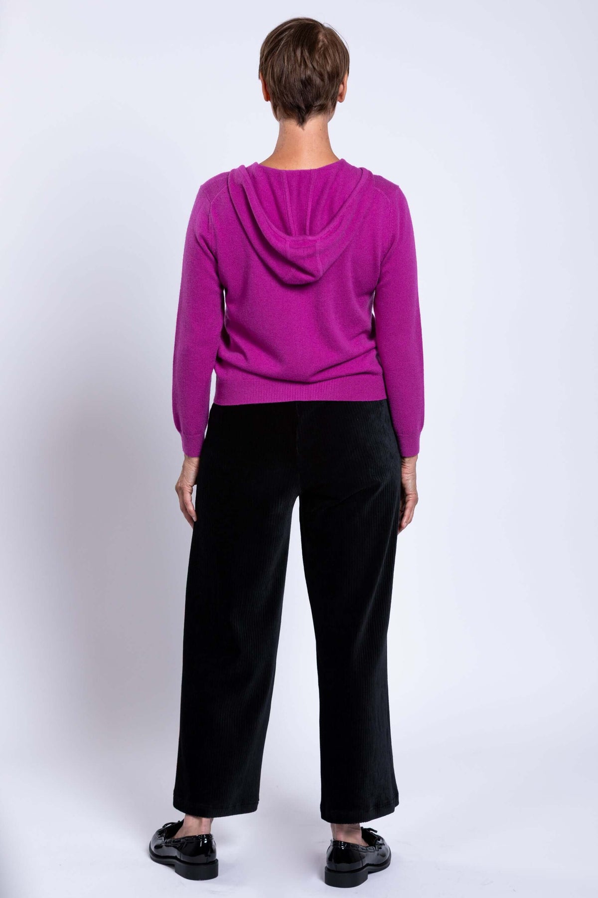 Back view of woman in magenta wool cashmere hoodie showing relaxed fit