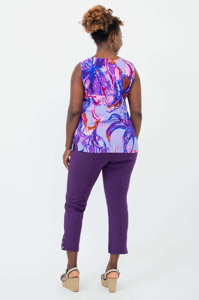 Rear view of a woman wearing a purple floral V-neck tank paired with purple pants