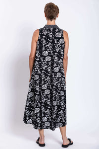 Rear view of sleeveless black and white A-line swing dress on model