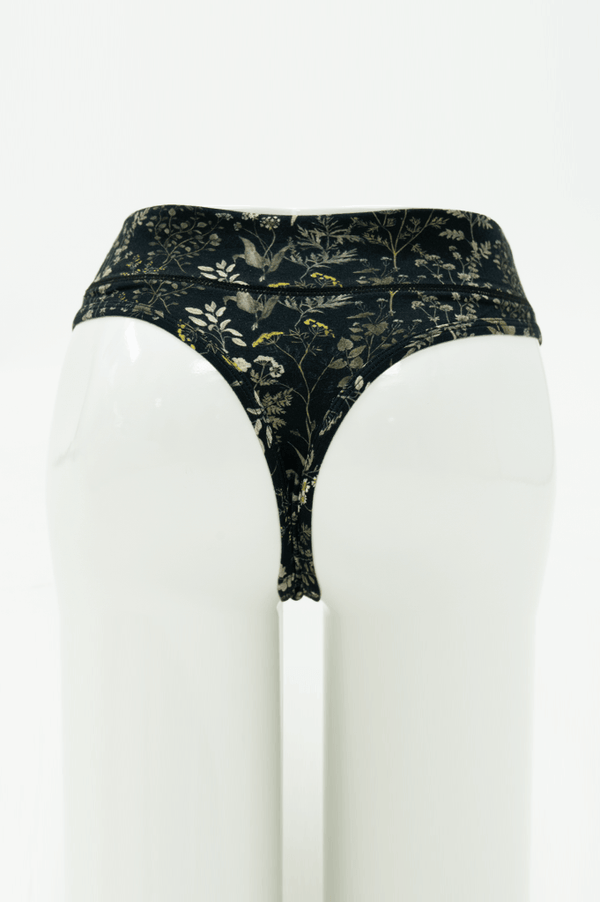 Rear view of high rise thong underwear in black with wildflower print
