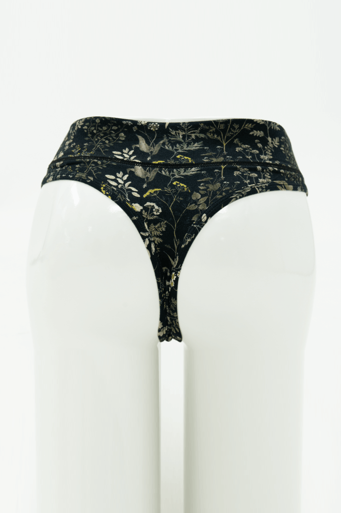 Rear view of high rise thong underwear in black with wildflower print