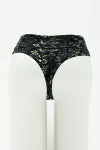 Rear view of high rise thong underwear in black with wildflower print