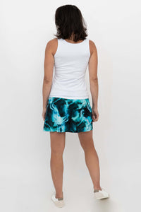Rear view of woman wearing Melly skirt-shorts in aqua marble