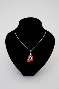 Sterling silver necklace with red teardrop pendant displayed on a black jewelry bust