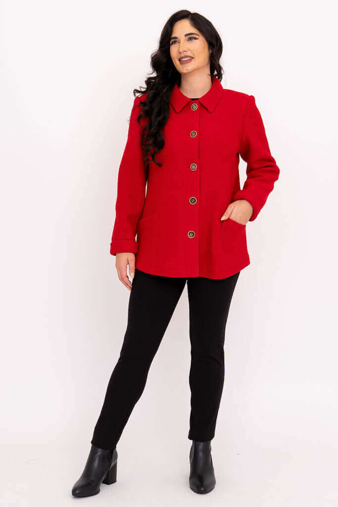 Woman standing with one hand in pocket, modeling a red wool blend coat
