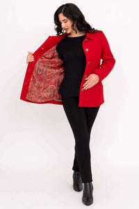 Woman showing the paisley silky lining inside a red wool blend coat