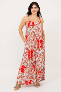 Woman in a red and cream boho patchwork jumpsuit with wide leg and pockets
