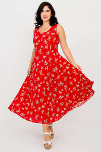 Woman twirling in a red sleeveless floral maxi dress, showing the full skirt movement