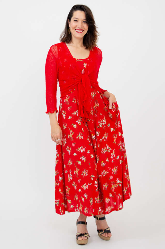 Woman wearing a red floral maxi dress with a matching red tie cardigan