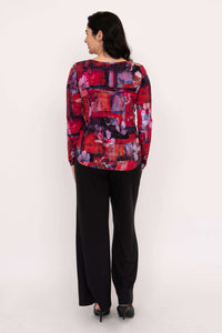 Back view of woman wearing red floral sweetheart neckline long sleeve top