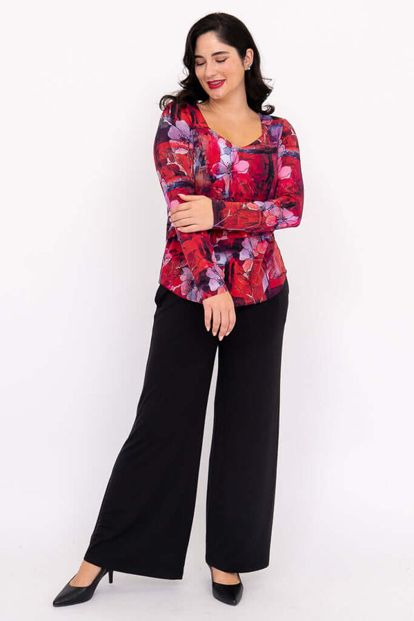 Woman wearing the red floral sweetheart top with arm folded, full body