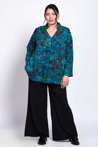 Relaxed pose showcasing Shirley Blouse’s drape and print with pockets