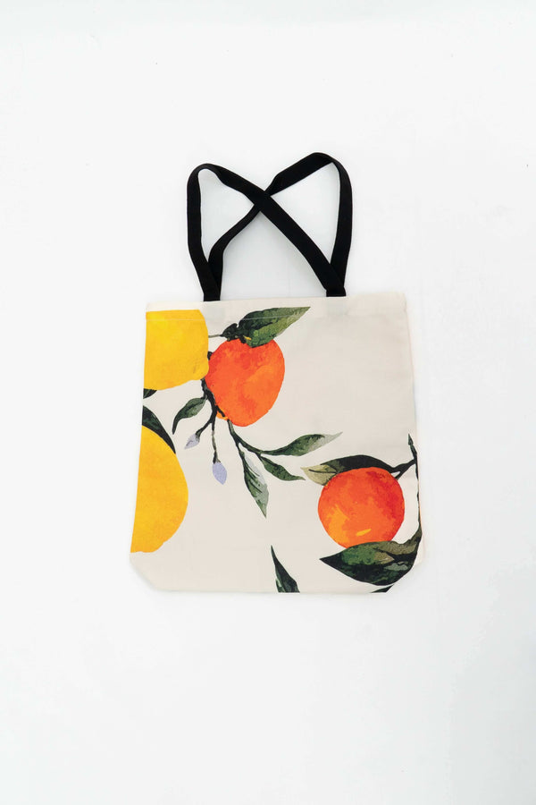 Reusable cotton tote bag with vibrant orange and yellow citrus design and black handles