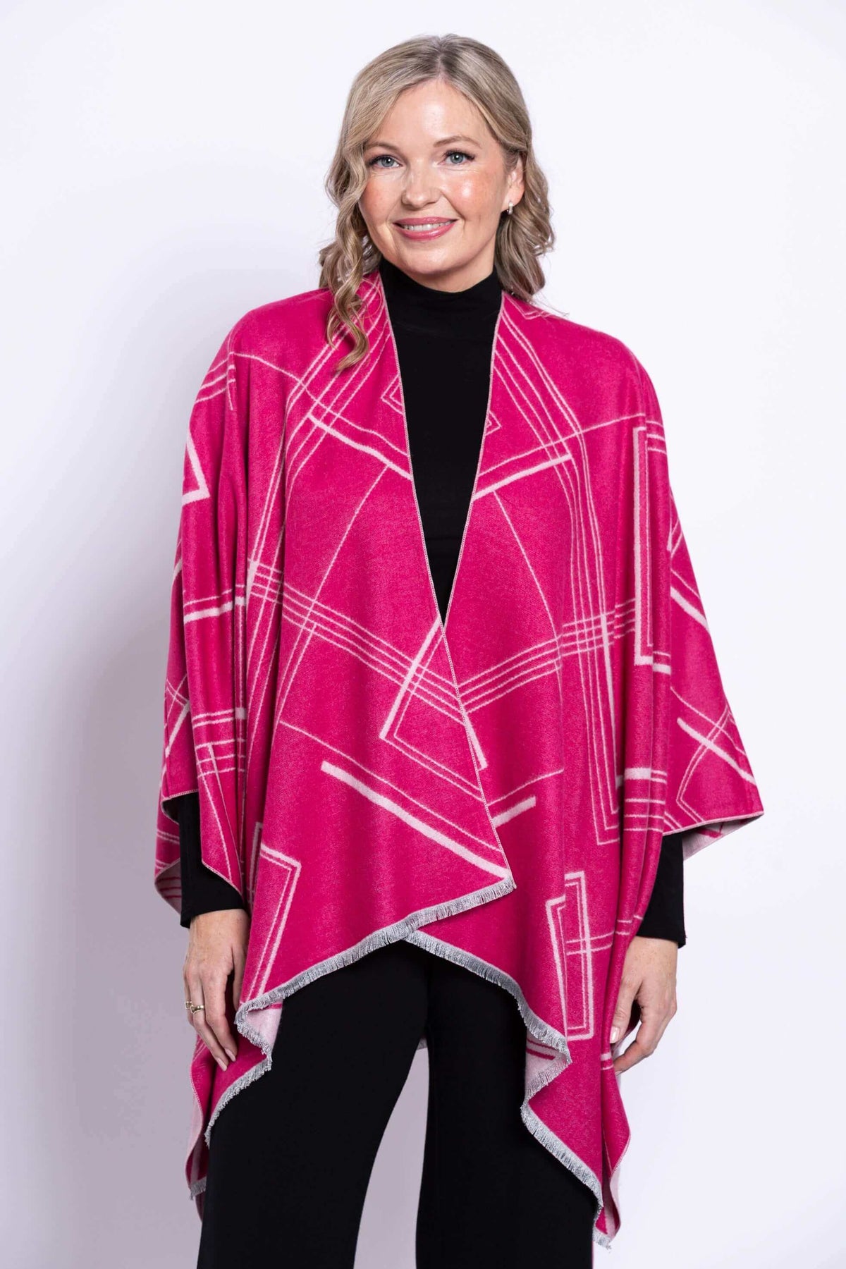 Woman wearing a reversible geometric wrap in fuchsia and pink, front view, closeup