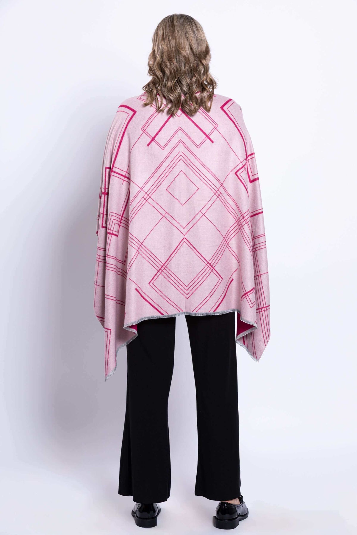 Back view of a reversible geometric wrap showing the pink side and geometric design