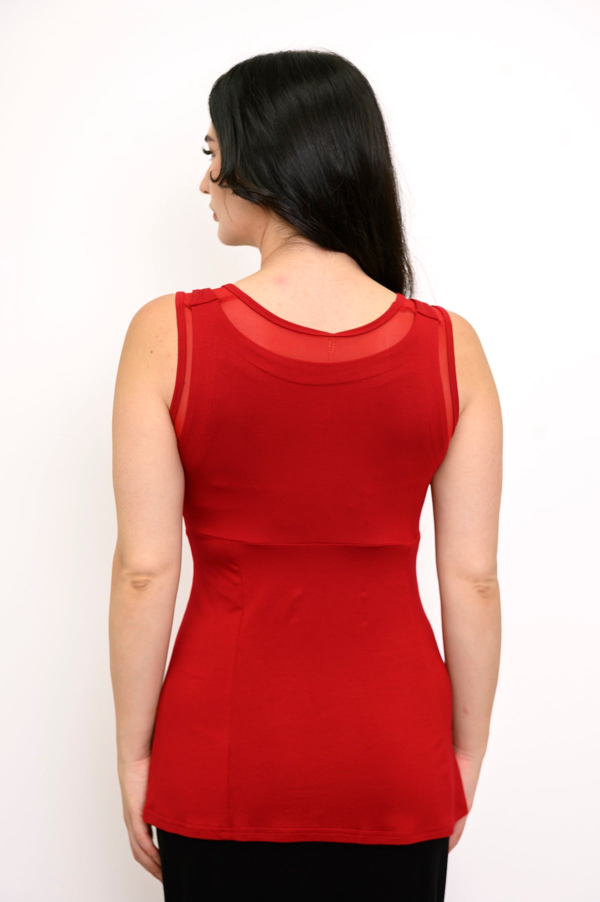 Back view of woman wearing red tank top with mesh detail and slim fit
