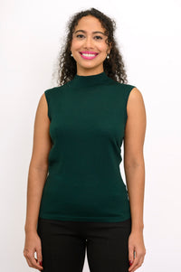 Studio portrait of a woman modeling a dark green sleeveless knit top with a classic fitted mock collar.