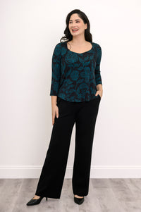 Draped teal leaf pattern pullover shirt with 3/4 sleeves, styled against a simple white background.