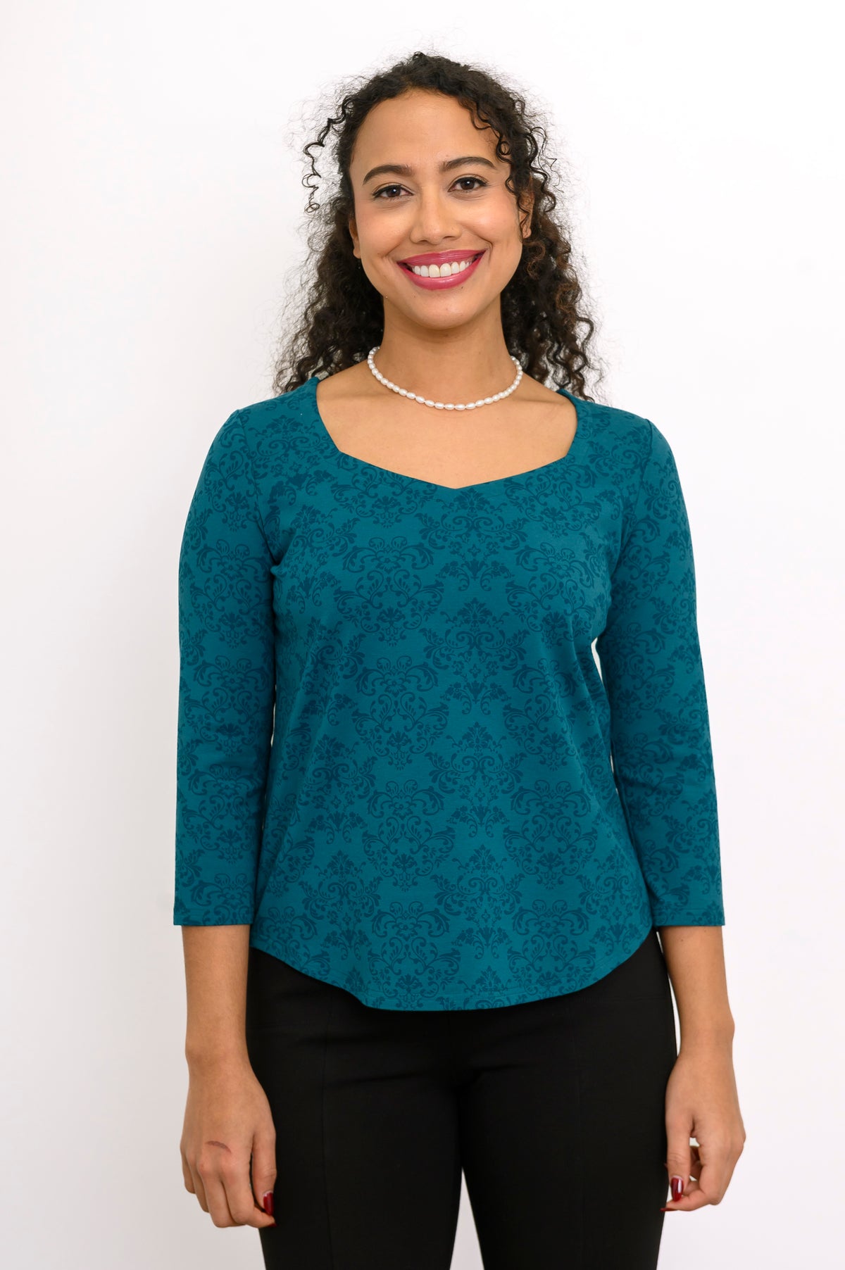 Front view of a teal patterned bamboo top showing the fluid, slightly rounded hemline and relaxed-fit midsection.