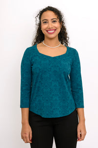 Front view of a teal patterned bamboo top showing the fluid, slightly rounded hemline and relaxed-fit midsection.