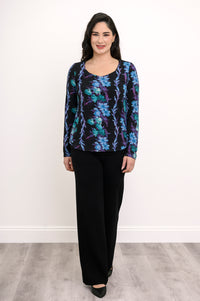 Model in a teal and black floral patterned long-sleeve bamboo top and black pants, front-facing view