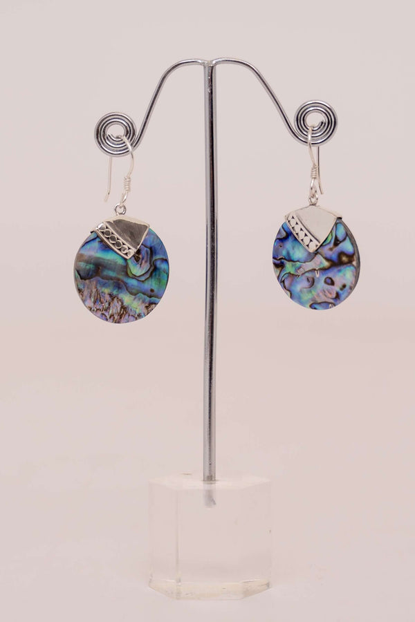 Pair of round abalone shell and sterling silver drop earrings on display stand