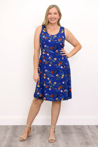 Front view of woman wearing a blue floral dress and sandals against a white background